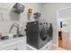 Laundry room with side by side washer and dryer, cabinets, sink, and hanging rack at 1035 Brentford Pl., Myrtle Beach, SC 29579
