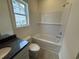 Bathroom featuring granite countertop, white subway tile and a tub with shower head at 1037 Jase Dr., Longs, SC 29568