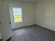 Bedroom with neutral paint, plush carpeting, and a window with a view of the backyard at 1037 Jase Dr., Longs, SC 29568