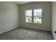 Bedroom with neutral paint, plush carpeting, and a window offering neighborhood views at 1037 Jase Dr., Longs, SC 29568