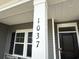 Closeup of home address on a pillar next to the window and a black front door with a smart lock at 1037 Jase Dr., Longs, SC 29568