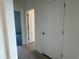 Hallway featuring neutral paint, wood-look floors, and multiple doors leading to other rooms at 1037 Jase Dr., Longs, SC 29568