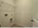 Neutral laundry room features wood-look flooring, a wire shelf, and laundry hookups for convenience at 1037 Jase Dr., Longs, SC 29568