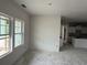 Bright room showcasing a view into the kitchen, a pass through, and multiple large windows at 1037 Jase Dr., Longs, SC 29568