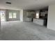 Open-concept living room with kitchen featuring bright windows and natural light at 1037 Jase Dr., Longs, SC 29568