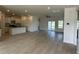Open-concept living space with wood-look floors, white walls, and a kitchen island at 1037 Jase Dr., Longs, SC 29568