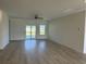 A spacious living room filled with natural light boasts sleek flooring and backyard access at 1037 Jase Dr., Longs, SC 29568
