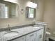 Bathroom featuring dual sinks, framed mirrors, granite countertops and vinyl floors at 104 Jessica Lakes Dr., Conway, SC 29526