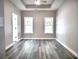 Bedroom with grey vinyl floors, ceiling fan, tray ceilings and natural lighting from several windows at 104 Jessica Lakes Dr., Conway, SC 29526