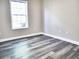 Bedroom featuring window with gray wood floors and neutral paint at 104 Jessica Lakes Dr., Conway, SC 29526