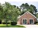 Charming brick home featuring a well-manicured lawn and an attached two-car garage at 104 Jessica Lakes Dr., Conway, SC 29526