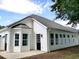 This home has a well-maintained white exterior, a dark roof, and a black entry door with plenty of windows at 104 Jessica Lakes Dr., Conway, SC 29526