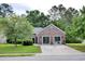 Traditional brick home with a well-kept lawn and mature trees offers great curb appeal and plenty of parking at 104 Jessica Lakes Dr., Conway, SC 29526