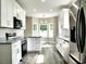 Bright kitchen featuring modern stainless steel appliances, granite counters, and a breakfast nook with great light at 104 Jessica Lakes Dr., Conway, SC 29526