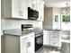 Modern kitchen features white cabinets, stainless steel appliances, granite countertops, and stylish finishes at 104 Jessica Lakes Dr., Conway, SC 29526