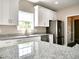 Clean kitchen featuring granite countertops, stainless steel appliances, and white cabinetry at 104 Jessica Lakes Dr., Conway, SC 29526