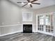 Living room with a fireplace, french doors and ceiling fan in neutral colors with grey vinyl floors at 104 Jessica Lakes Dr., Conway, SC 29526