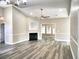 Spacious living room with fireplace, large windows, ceiling fan, and wood-look flooring at 104 Jessica Lakes Dr., Conway, SC 29526