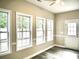 Living room featuring three windows, and a back door, with grey vinyl floors at 104 Jessica Lakes Dr., Conway, SC 29526