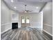Living room with a fireplace and a ceiling fan in neutral colors with grey vinyl floors at 104 Jessica Lakes Dr., Conway, SC 29526