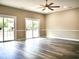 Living room featuring two sliding doors with gray wood floors and neutral paint at 104 Jessica Lakes Dr., Conway, SC 29526