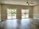 Bright living room featuring modern flooring, a ceiling fan, and sliding glass doors to the outside at 104 Jessica Lakes Dr., Conway, SC 29526