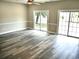 An open living room area with two sliding doors, providing ample natural light, and neutral walls at 104 Jessica Lakes Dr., Conway, SC 29526