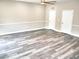 Living room featuring neutral paint with gray wood floors and two white doors at 104 Jessica Lakes Dr., Conway, SC 29526