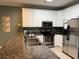 Well-lit kitchen featuring granite countertops, stainless steel appliances, and white cabinetry at 112 B 12Th Ave. N, Surfside Beach, SC 29575