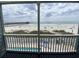 View from the balcony featuring the beach, ocean and pier at 116 S Waccamaw Dr. # 205, Murrells Inlet, SC 29576