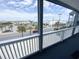 Balcony view of the street with palm trees and buildings at 116 S Waccamaw Dr. # 205, Murrells Inlet, SC 29576