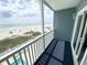 Balcony view of the beach with ocean view, sandy beach, and blue skies at 116 S Waccamaw Dr. # 205, Murrells Inlet, SC 29576