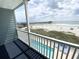Balcony view overlooks the beach, ocean, and pier at 116 S Waccamaw Dr. # 205, Murrells Inlet, SC 29576