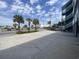 Exterior view of a building with palm trees, parking spaces and blue sky at 116 S Waccamaw Dr. # 205, Murrells Inlet, SC 29576