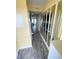 Hallway with wood-look floors, mirrored walls, and access to bunk rooms at 116 S Waccamaw Dr. # 205, Murrells Inlet, SC 29576