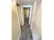 Long hallway with light wood-look floors and white doors and trim at 116 S Waccamaw Dr. # 205, Murrells Inlet, SC 29576