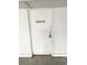 Laundry room door with sign on the outside of a white paneled building and concrete floor at 116 S Waccamaw Dr. # 205, Murrells Inlet, SC 29576