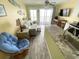 Inviting living space with a view from the kitchen area to the couch, TV, balcony and the beach beyond at 116 S Waccamaw Dr. # 205, Murrells Inlet, SC 29576