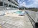 Inviting pool area with lounge chairs at an exterior of condo building at 116 S Waccamaw Dr. # 205, Murrells Inlet, SC 29576