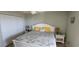 Bedroom with queen bed, lamps, ceiling fan, and wall decorations at 1311 S Ocean Blvd. # B-1, North Myrtle Beach, SC 29582