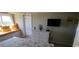 Bedroom with dresser, TV and access to the balcony at 1311 S Ocean Blvd. # B-1, North Myrtle Beach, SC 29582