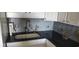 Kitchen sink with white cabinets and granite countertops at 1311 S Ocean Blvd. # B-1, North Myrtle Beach, SC 29582