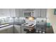 Well-lit kitchen with white cabinets, sleek countertops, stove top and modern appliances at 1311 S Ocean Blvd. # B-1, North Myrtle Beach, SC 29582