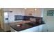 Bright kitchen with white cabinets, appliances and breakfast bar with granite countertops at 1311 S Ocean Blvd. # B-1, North Myrtle Beach, SC 29582