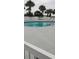 Inviting community pool surrounded by a white fence and lush tropical landscaping at 1311 S Ocean Blvd. # B-1, North Myrtle Beach, SC 29582