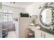 Bright bathroom featuring a decorative mirror and white cabinetry at 134 Mohican Dr., Georgetown, SC 29440