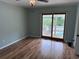Bright bedroom with hardwood floors and a sliding glass door leading to an outdoor space at 134 Mohican Dr., Georgetown, SC 29440