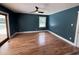 Cozy bedroom with wood floors, a modern ceiling fan, and a door leading to the deck at 134 Mohican Dr., Georgetown, SC 29440