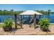 View of a shady boat dock equipped with wood rails and plank steps down to the water at 134 Mohican Dr., Georgetown, SC 29440