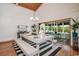 Bright dining room with vaulted ceiling, chandelier, and view to the screened porch at 134 Mohican Dr., Georgetown, SC 29440